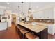 Spacious kitchen with granite countertops, a large center island with seating, and stainless steel appliances at 915 Preservation Circle, Pawleys Island, SC 29585