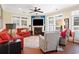 Cozy living room boasts a fireplace, large windows with plantation shutters, and comfortable seating arrangement at 915 Preservation Circle, Pawleys Island, SC 29585