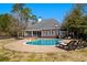 A luxurious pool offers a relaxing outdoor oasis with lounge chairs and a backdrop of a brick house at 915 Preservation Circle, Pawleys Island, SC 29585