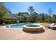 Backyard pool with hot tub and lounge chairs with a well-maintained lawn at 915 Preservation Circle, Pawleys Island, SC 29585