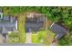 Aerial view of the property showcasing the roof, driveway, backyard, and surrounding landscaping at 945 Castlewood Dr., Conway, SC 29526