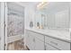 Bathroom with marble countertop, framed mirror, and marble patterned shower at 945 Castlewood Dr., Conway, SC 29526