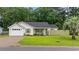 Charming single-story home with a lush green lawn and a well-manicured landscape at 945 Castlewood Dr., Conway, SC 29526