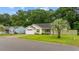 Charming single-story home with a well-manicured lawn, driveway, and tropical landscaping at 945 Castlewood Dr., Conway, SC 29526