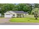 Charming one-story home with well-manicured lawn, cozy front patio, and attached single-car garage at 945 Castlewood Dr., Conway, SC 29526