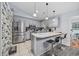 Spacious kitchen with stainless steel appliances, breakfast bar, tiled flooring, and gray color palette at 945 Castlewood Dr., Conway, SC 29526
