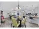 Open kitchen and dining area with modern white cabinets, a tile backsplash, and modern light fixtures at 945 Castlewood Dr., Conway, SC 29526