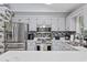 Updated kitchen features stainless steel appliances, gray cabinets, stylish backsplash, and ample counter space at 945 Castlewood Dr., Conway, SC 29526