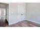 Cozy bedroom with wood-look flooring, featuring a closet and view into the hallway at 2212 Old Charleston Rd., Georgetown, SC 29440