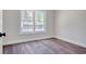 Bedroom with luxury vinyl flooring and a bright window at 2212 Old Charleston Rd., Georgetown, SC 29440