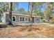 Attractive single-story home with neutral siding, framed by mature trees and natural surroundings at 2212 Old Charleston Rd., Georgetown, SC 29440