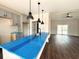 Open floorplan kitchen with a large island and stainless steel sink, overlooking the spacious living room at 2212 Old Charleston Rd., Georgetown, SC 29440