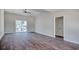 Spacious living room featuring vaulted ceilings, wood-look flooring, and sliding glass door to the exterior at 2212 Old Charleston Rd., Georgetown, SC 29440