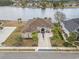 Stunning aerial view of a luxury single-Gathering home with a brick drive, mature landscaping, and a waterfront view at 1012 Dowitcher Dr., Conway, SC 29526