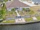 Aerial view showcasing the backyard patio, waterfront access, and lush landscaping surrounding the property at 1012 Dowitcher Dr., Conway, SC 29526