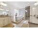 Bright bathroom featuring a soaking tub, glass shower, and dual vanities with granite countertops at 1012 Dowitcher Dr., Conway, SC 29526