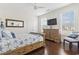 Bright bedroom with beachy decor, hardwood floors, and a decorative mirror at 1012 Dowitcher Dr., Conway, SC 29526