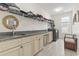 Functional laundry room with granite countertop, storage cabinets, and laundry sink at 1012 Dowitcher Dr., Conway, SC 29526