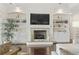 Cozy living room featuring a fireplace, built-in shelving, and hardwood floors at 1012 Dowitcher Dr., Conway, SC 29526