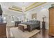 Spacious main bedroom with hardwood floors, tray ceiling, chandelier, and waterfront views through the windows at 1012 Dowitcher Dr., Conway, SC 29526