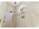 Elegant shower with mosaic tile accents, built-in shelving, and rainfall shower head at 1012 Dowitcher Dr., Conway, SC 29526