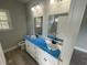 Bathroom featuring double vanity, marbled countertop, and a large mirror awaiting final touches at 10534 W Highway 19, Loris, SC 29569