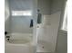 Bathroom with a white soaking tub and shower with matte black fixtures at 10534 W Highway 19, Loris, SC 29569
