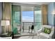 Comfortable chair seating on the balcony with sliding glass doors overlooking ocean views at 107 S Ocean Blvd. # 2106, Myrtle Beach, SC 29577