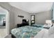 Bright bedroom features two beds with patterned spreads, a television, and doorway to another room at 107 S Ocean Blvd. # 2106, Myrtle Beach, SC 29577