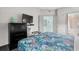 Well-lit main bedroom with a modern dresser, large television, and easy access to ensuite bath at 107 S Ocean Blvd. # 2106, Myrtle Beach, SC 29577