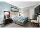 Bright main bedroom with a colorful floral bedspread, modern lamps, and dresser at 107 S Ocean Blvd. # 2106, Myrtle Beach, SC 29577