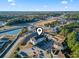 Drone shot showcasing the proximity to water features, parking and mature tree cover at 110 South Shore Blvd. # 302, Longs, SC 29568
