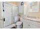 Bathroom with white cabinets, framed mirror, and tiled shower at 110 South Shore Blvd. # 302, Longs, SC 29568