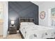A bedroom featuring a statement wall, light-filled window, and stylish furnishings at 110 South Shore Blvd. # 302, Longs, SC 29568