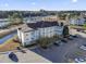 Exterior view of a condo with multiple floors, parking, and pond at 110 South Shore Blvd. # 302, Longs, SC 29568