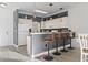 Cozy kitchen with white cabinets, countertops, and three barstools at 110 South Shore Blvd. # 302, Longs, SC 29568