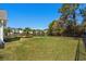 Beautiful backyard with green grass and a lovely view of the pond beyond the black metal fence at 1205 Woodruff Ct., Conway, SC 29526