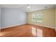 Bright and airy bedroom with hardwood floors and large window at 1205 Woodruff Ct., Conway, SC 29526