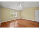 Spacious bedroom with hardwood floors, a ceiling fan, and natural light from a window at 1205 Woodruff Ct., Conway, SC 29526
