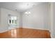 Bright dining room with hardwood floors, elegant chandelier, and view to sunroom at 1205 Woodruff Ct., Conway, SC 29526