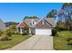 Charming brick home featuring a two-car garage, well-manicured lawn, and a welcoming front yard at 1205 Woodruff Ct., Conway, SC 29526