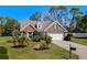 Charming home exterior with a well-manicured lawn and colorful flower beds at 1205 Woodruff Ct., Conway, SC 29526