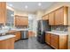 Modern kitchen with stainless steel appliances, mosaic backsplash, and wood cabinetry at 1205 Woodruff Ct., Conway, SC 29526