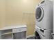 Well-equipped laundry room featuring a stacked washer and dryer with storage at 1205 Woodruff Ct., Conway, SC 29526