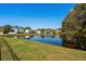 Scenic view of a pond with a fountain surrounded by lush greenery and neighboring homes at 1205 Woodruff Ct., Conway, SC 29526