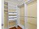 Organized walk-in closet featuring white shelving and drawers, offering efficient storage solutions at 1205 Woodruff Ct., Conway, SC 29526