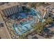 Aerial view of the community waterpark with slides, pools, and palm tree landscaping at 1207 S Ocean Blvd. # 20206, Myrtle Beach, SC 29577