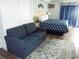 Cozy bedroom featuring a blue sofa, patterned rug, and comfortable sleeping area at 1207 S Ocean Blvd. # 20206, Myrtle Beach, SC 29577