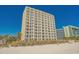 Oceanfront condo building with private balconies and beach access on a bright sunny day at 1207 S Ocean Blvd. # 20206, Myrtle Beach, SC 29577