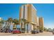 Hotel exterior featuring ample parking and scenic palm tree landscaping at 1207 S Ocean Blvd. # 20206, Myrtle Beach, SC 29577